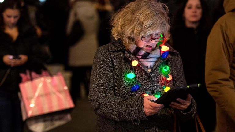 Rockefeller Center Christmas tree lighting: See photos 33 A woman walks up Fifth Avenue wearing Christmas tree lights. Preparations for the Rockefeller Center Christmas Tree Lighting in NYC on Nov. 28, 2018.