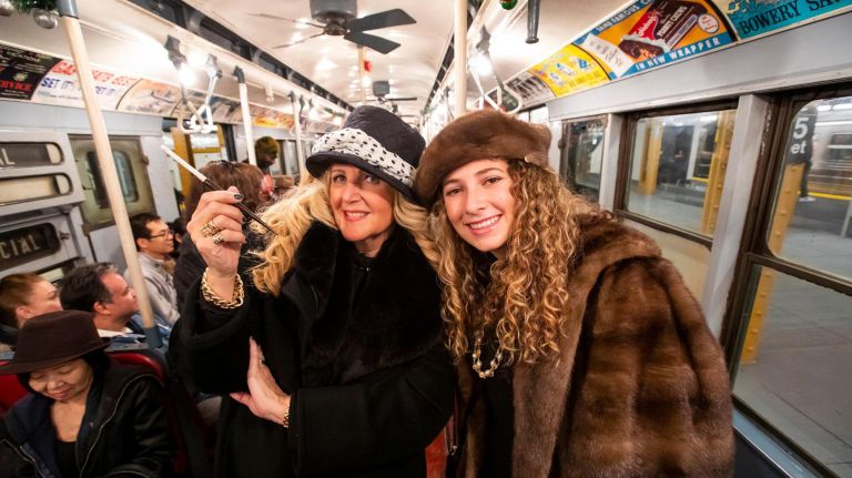 Inside the MTA nostalgia train 12 Silvia Gerber of Manhattan with her daughter Ashley Gerber of Manhattan, both in 1930s attire on the holiday vintage 1930's R1-9 train car.