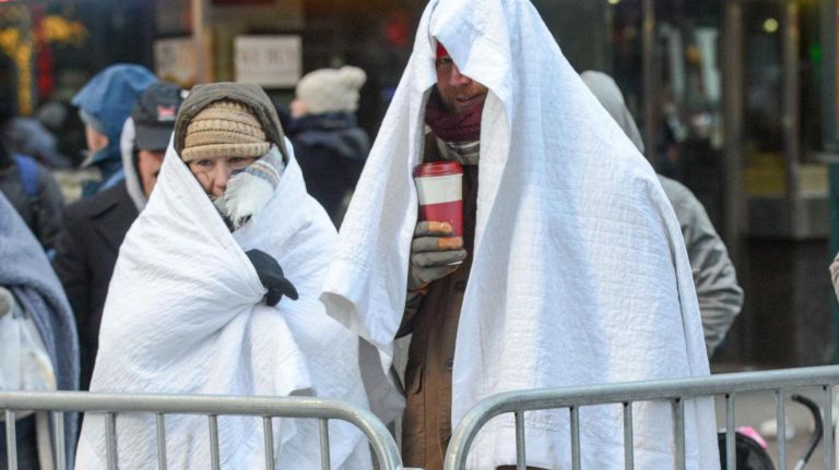 People are bundled up in many different ways before the Macy's Thanksgiving Parade on Thursday.