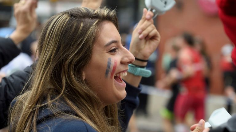 Travert Clemence, from Cherbourg, France, cheers from the sidelines on 48th Avenue in Queens as she waits for her father to run by during the 2017 TCS New York City Marathon on Sunday, Nov. 5, 2017. 