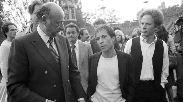 Mayor Edward Koch, left, greets Paul Simon, center, and Art Garfunkel at Central Park before the duo's iconic reunion concert on Sept. 19, 1981, held to raise $3 million to put toward the park's restoration. 