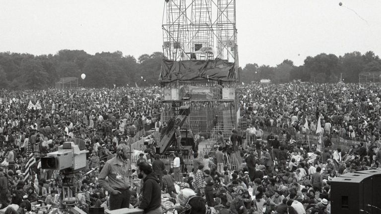 Crowds react as they listen to Paul Simon and Art Garfunkel perform on stage at the Great Lawn in Central Park on Sept.19, 1981. 