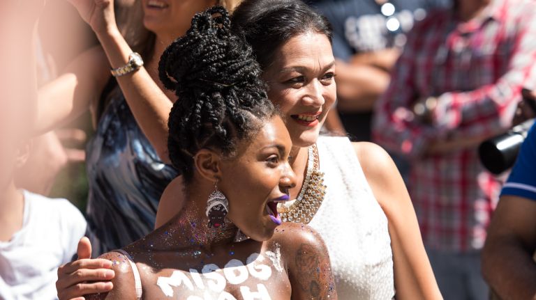 Rouge, 28, of Brooklyn takes a photo with Wei Fen Chen, also of Brooklyn, during the GoTopless Day Parade in Manhattan on Saturday, Aug. 26, 2017. 