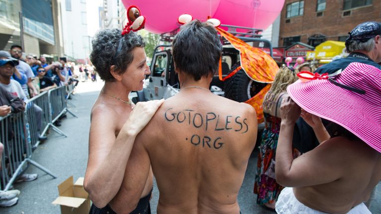 Men and women take part in the 10th annual GoTopless Day parade on 58th Street between Eighth and Ninth avenues in Manhattan on Saturday, Aug. 26, 2017.