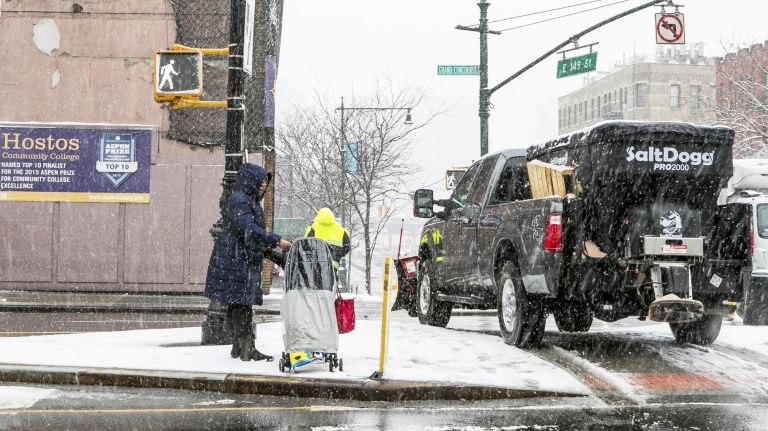 Pedestrians and salt spreaders converge at Grand Concourse and 149th Street in the Bronx, March 21, 2018.
