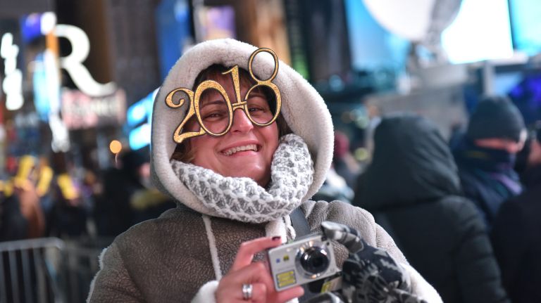 New Year's Eve revelers get ready to celebrate in a frigid Times Square on Sunday, Dec. 31, 2017.