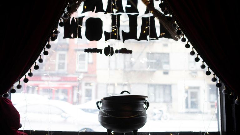 An Irish cauldron from the 1700s that was said to actually be used to create potions sits in the window and emits "steam."
