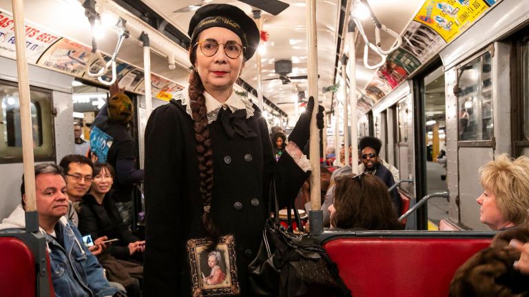 Inside the MTA nostalgia train 10 Mary Alice Ladd of the Bronx is dressed in vaguely early 1900's attire on the holiday vintage 1930's R1-9 train car. She has participated every year since 2008 with different outfits every weekend. It's a "chance to travel back in time and actually enjoy the subways."