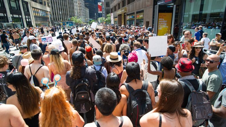 Men and women take part in the 10th annual GoTopless Day parade in Manhattan on Saturday, Aug. 26, 2017. 