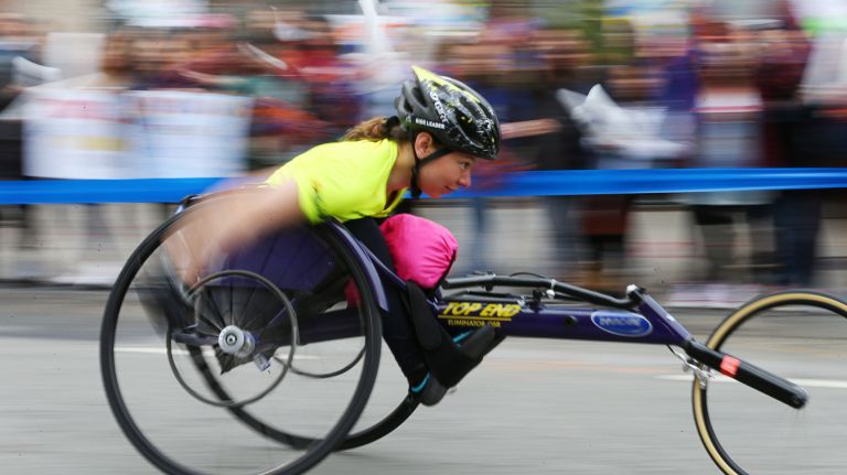 A competitor in the wheelchair division passes through the Long Island City section of Queens during the 2017 TCS New York City Marathon on Sunday, Nov. 5, 2017.