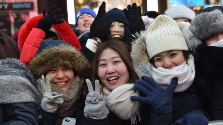 New Year's Eve revelers get ready to celebrate in a frigid Times Square on Sunday, Dec. 31, 2017.