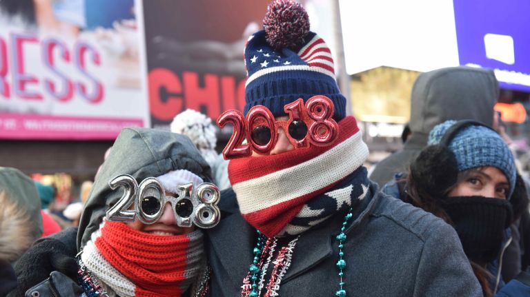 New Year's Eve revelers get ready to celebrate in a frigid Times Square on Sunday, Dec. 31, 2017.