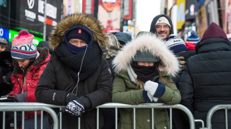 Daniel Morales, 29, and Carolina Restrepo, 26, both from Bogota, Colombia, are bundled up in Times Square before the New Year's Eve celebration on Sunday, Dec. 31, 2017.