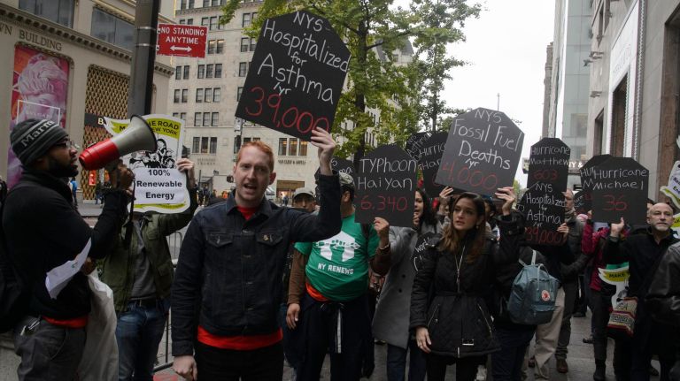 State Senate candidate Julia Salazar, center, joins protesters outside Trump Tower to call for stringent climate legislation.