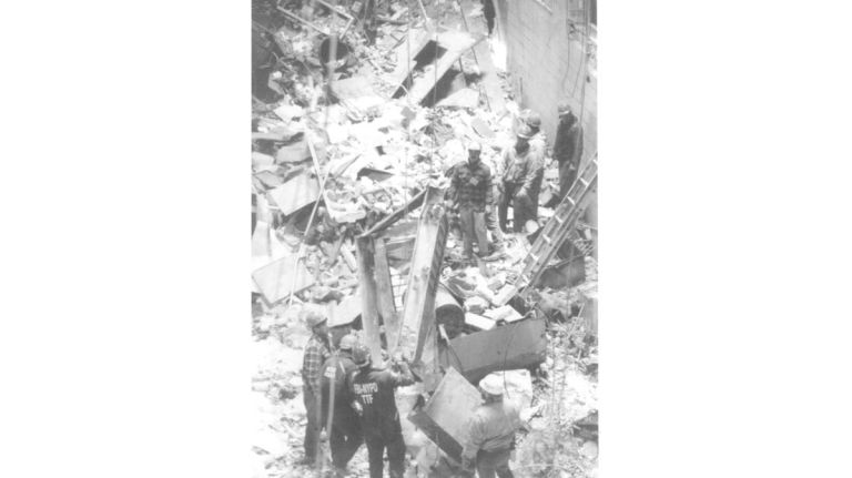 Workers load debris from the crater left by the bombing at the World Trade Center's north tower onto a scoop on March 12, 1993, to be carted away to the Fresh Kills Landfill in Staten Island.