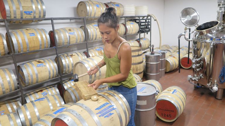 Marie Estrada, a co-founder of M&Ocirc;T&Ocirc; Spirits&nbsp;in Bushwick, seen here removing the bung from a barrel.