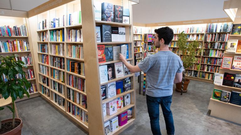 A customer peruses the book selection inside McNally Jackson.