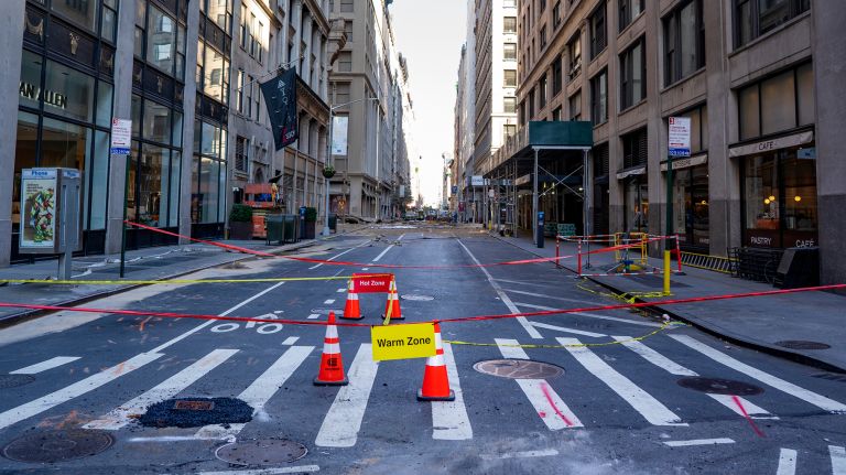 Just east of Fifth Ave. and 21st Street in Manhattan Friday, signs mark off-limits zones in the aftermath of a massive steam pipe explosion that sent smoke, mud and steam billowing into the air Thursday morning. 