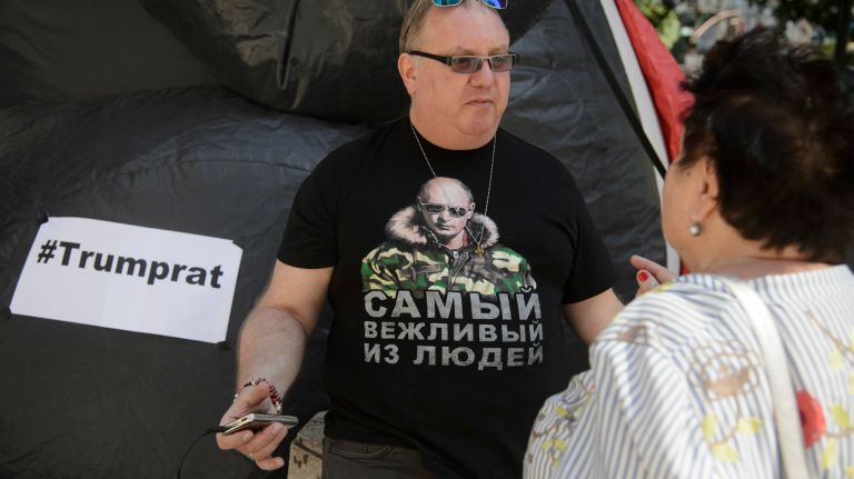 Matthew Drutt, a co-producer of the Trump Rat project, translates his Vladimir Putin shirt as, 