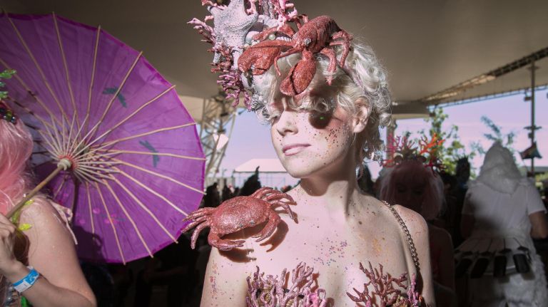 A coral-clad mermaid poses before entering the annual Coney Island Mermaid Parade.
