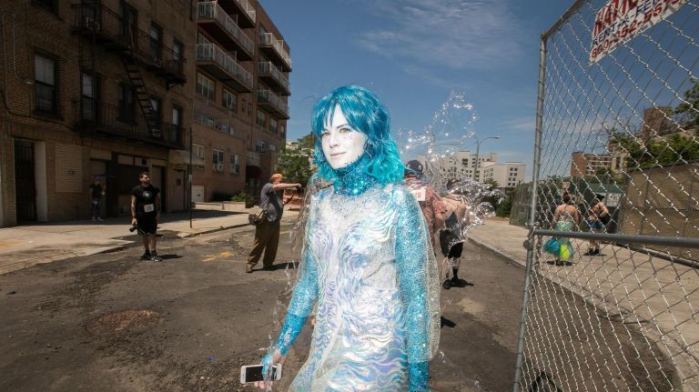 A wave-like mermaid walks to the parade.