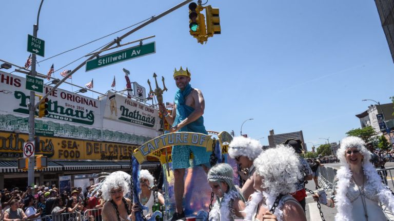 A man dressed as Neptune rides a float at the Mermaid Parade in Coney Island.