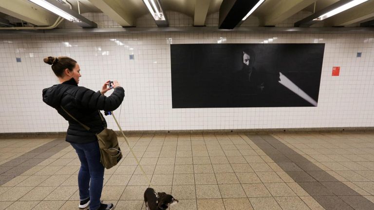 Sarah Natoli and her dog Scrappy check out the David Bowie exhibit.