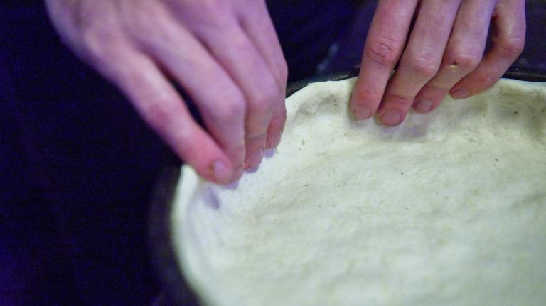 A look inside Emmett's, offering Chicago-style pizza in NY 10 Emmett Burke hand forms the two-inch high crusts that provide the base for deep dish pizza.