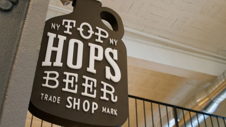 At Top Hops Beer Shop's counter, you will be able to top off your crowler (a giant 32-ounce can) and order bratwursts and pretzels.