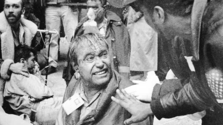 An injured man is assisted by emergency workers after the explosion at the World Trade Center's north tower on Feb. 26, 1993.