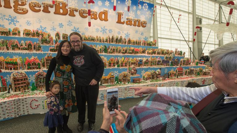 GingerBread Lane creator Jon Lovitch with Xiaoou Ji and her daughter Kiyue Zhu, 4, of Flushing, at the New York Hall of Science in Corona on Nov. 26, 2017.