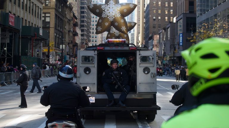 Members of the NYPD's Emergency Service Unit ride in an armored vehicle on Sixth Avenue. 