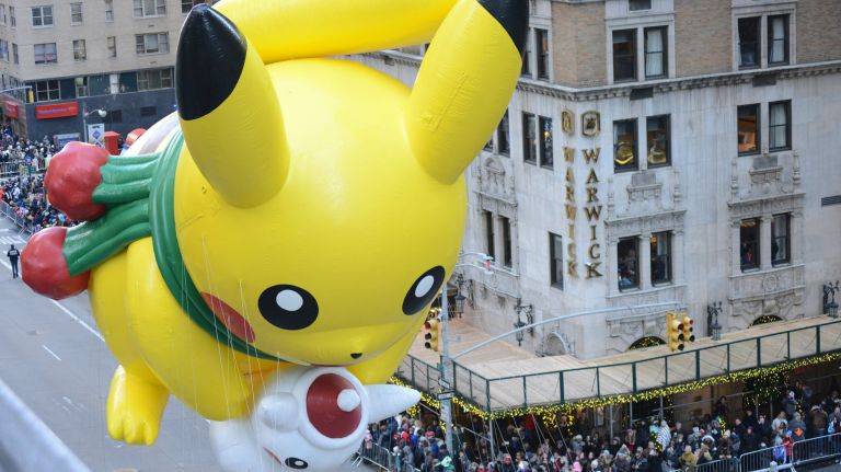 Pikachu cruises by the crowds on Sixth Avenue.