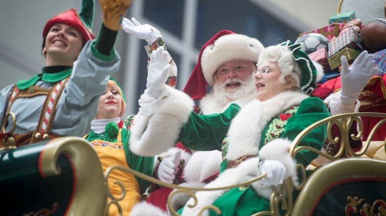 Mr. and Mrs. Santa Claus wave to the crowds as their float passes along Sixth Avenue near 59th Street in Manhattan on Thursday, Nov. 24, 2016, bringing up the rear of the 90th annual Macy's Thanksgiving Day Parade.