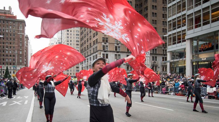 Performers wave snowflake banners on Thursday, Nov. 24, 2016, during the 90th annual Macy's Thanksgiving Day Parade.