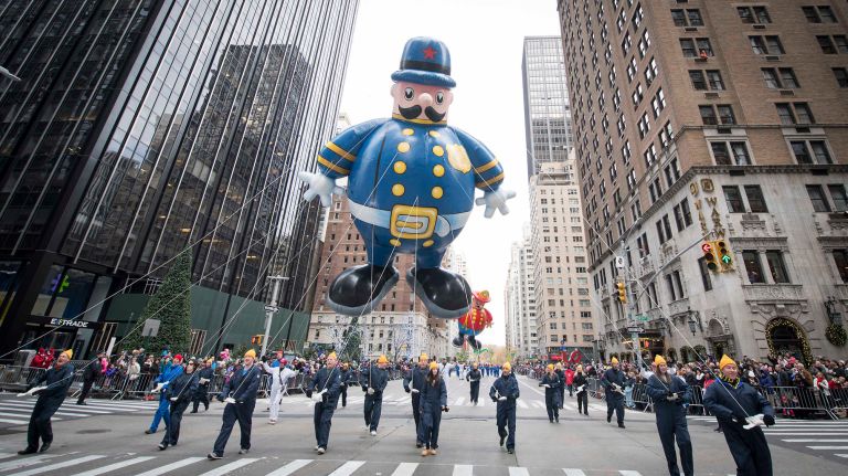 The NYPD marching band accompanies the Harold the Policeman balloon as it floats down Sixth Avenue near 59th Street on Thursday, Nov. 24, 2016, during the Macy's Thanksgiving Day Parade.
