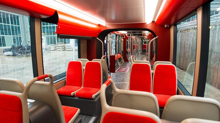 The prototype, which features plush red decor and leaning cushions, aims to provide equal transportation access for all neighborhoods along the Brooklyn-Queens waterfront, according to Friends of BQX. 