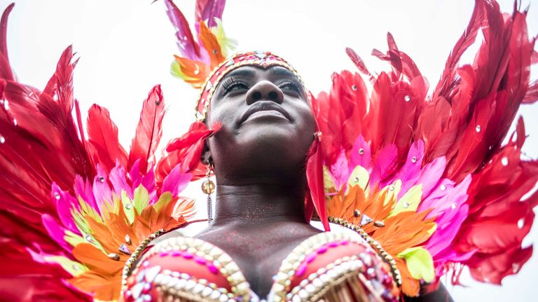 Costumed dancers get ready to march in the West Indian Day Parade along Eastern Parkway in Brooklyn on Monday, Sept. 5, 2016.