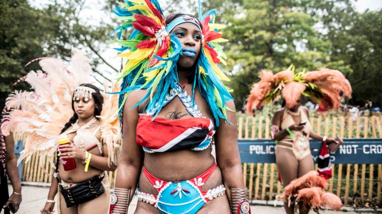Costumed dancers get ready to march in the West Indian Day Parade along Eastern Parkway in Brooklyn on Monday, Sept. 5, 2016.