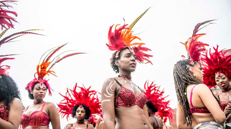 Costumed dancers get ready to march in the West Indian Day Parade along Eastern Parkway in Brooklyn on Monday, Sept. 5, 2016.