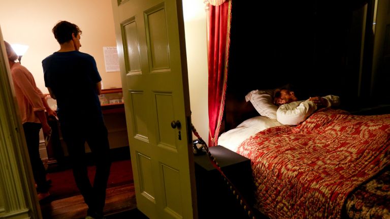 A mask of Seabury Tredwell lies on his deathbed on Oct. 11 at the exhibit called "A Good Death: 19th Century Lessons in Dying Well," which is part of the Halloween events at the Merchant's House Museum on E.&nbsp;4th Street.