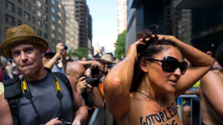 People prepare for the GoTopless Pride Parade on Sunday, Aug. 28, 2016, in Manhattan. 