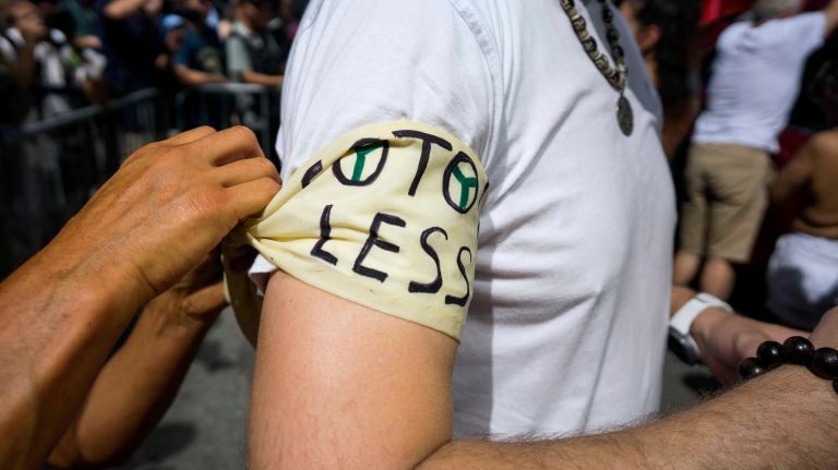 People prepare for the GoTopless Pride Parade on Sunday, Aug. 28, 2016, in Manhattan. 