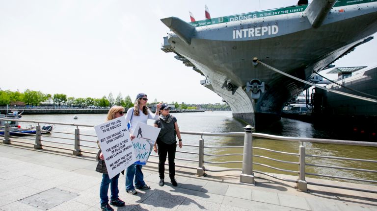 Protestors outside the Intrepid Air and Space museum, before the president's visit to the decommissioned aircraft carrier on May 4, 2017.