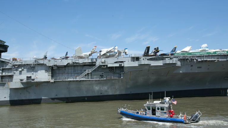 NYPD boat patrols the waters near the Intrepid Air and Space Museum, before the president's visit to the decommissioned aircraft carrier on May 4, 2017.