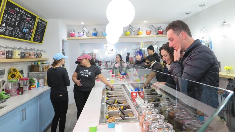 Customers select their flavors much like you might at an ice cream shop -- with tubs behind a glass pane to be served by the scoop, along with toppings.