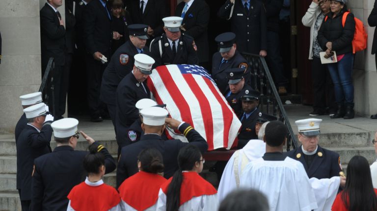 The coffin of FDNY EMT Yadira Arroyo is carried from St. Nicholas of Tolentine Roman Catholic Church on Saturday, March 25, 2017, after her funeral.