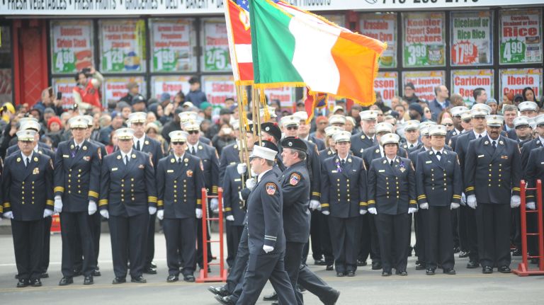 An FDNY procession makes its way on the street near St. Nicholas of Tolentine Roman Catholic Church on University Avenue in the Bronx on Saturday, March 25, 2017, before the arrival of an ambulance carrying the coffin of FDNY EMT Yadira Arroyo.