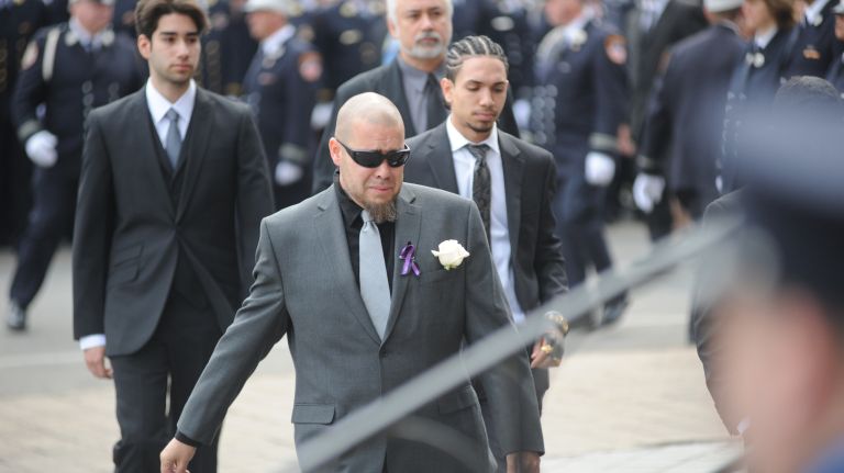 Friends and family members arrive Saturday, March 25, 2017, for the funeral Mass of FDNY EMT Yadira Arroyo at St. Nicholas of Tolentine Roman Catholic Church on University Avenue in the Bronx.