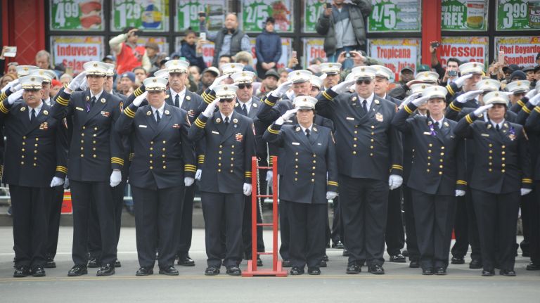 Members of the FDNY salute the coffin carrying EMT Yadira Arroyo as it is taken into St. Nicholas of Tolentine Roman Catholic Church on University Avenue in the Bronx on Saturday, March 25, 2017.